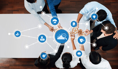 A dynamic scene of diverse professionals collaborating around a table, showcasing icons that...