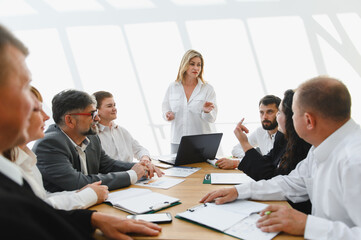 Business team meeting with female leader discussing strategy for success