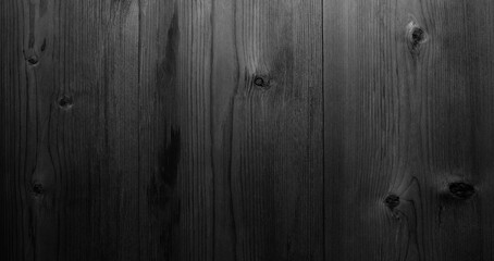 dark  black wooden surface with a grainy texture.  wood is dark and has a natural look abstract...