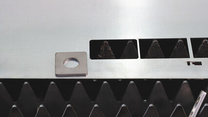 metal sheet is placed on the surface. plate is made of metal and has a rough texture. It is placed...