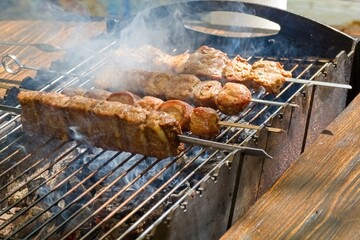  Juicy pieces of meat skewered and grilled over hot charcoal, releasing flavorful smoke.