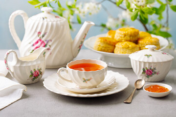 Traditional English tea scones with jam. Grey and blue background. Close up.