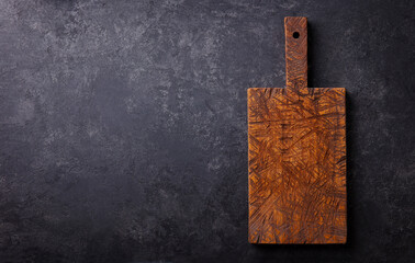 Wooden cutting board for serving cheese. Copy space for design elements or text. Anthracite stone...