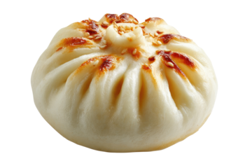 Close-up of a round, light-colored bao bun.  Golden-brown edges