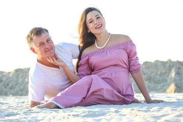Romantic couple enjoys a sunny day on the beach while posing for a candid moment