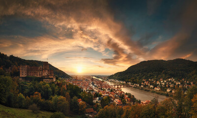 View of Heidelberg, Germany, from above, with dramatic red clouds in the sunset sky and warm light