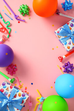 Colorful birthday party flat lay on pink background with balloons and gifts