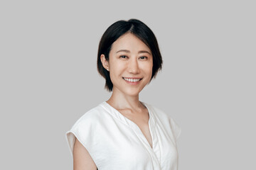 Smiling eastern sophisticated female entrepreneur ceo leader businesswoman isolated. Closeup headshot face portrait of mature Asian executive office manager business woman looking confident at camera