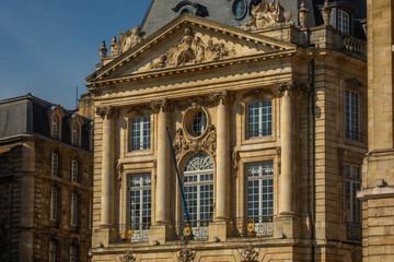 Facade of an elegant historical Palace Building with big Windows,  Columns, and Decorations in Bordeaux, France; Close-up