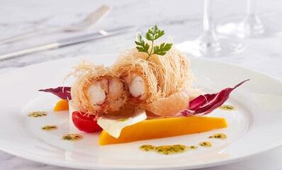 Kataifi Shrimp with Thai Mango Salad, Grapefruit, Radicchio, and Herb Oil on a White Plate closeup side view of restaurant menus