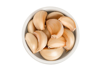 garlic cloves in ceramic bowl isolated on white background close up. Top view. Flat lay.