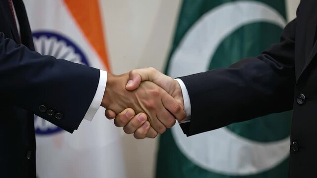 Close-Up Diplomatic Handshake Between India and Pakistan Delegates with Blurred Flags in Background &ndash; 4K

