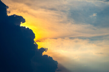 Majestic sunset behind dark clouds creates a breathtaking contrast in the evening sky