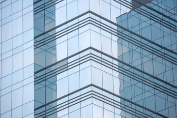 Reflections on modern architecture in a glass building showcasing structural elegance