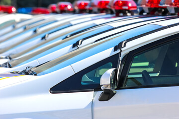 Police vehicles lined up during daytime for community safety operations in urban area