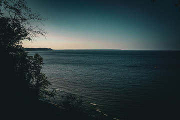 In the evening coastal scene with a dark mood and still sea, view along the coast of the Baltic Sea...