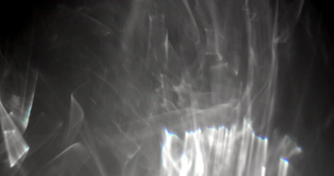 Caustic reflections on dark background. Abstract caustic reflections on black. Can be used as overlay elements for your projects, video texture or background for designs, scenes, etc. 
