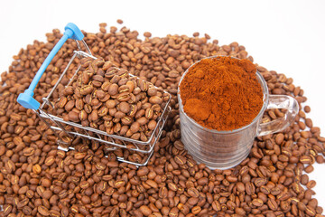 Freshly roasted coffee beans and ground coffee in a shopping cart on a white background