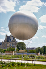 Tethered helium balloon above Paris Tuileries garden with Louvre in background on June 17 2025...
