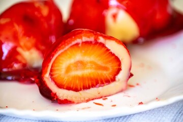 The iconic and delicious Brazilian strawberry of love, prepared with fresh strawberries, white brigadeiro and crunchy caramel on the surface. Morango do amor