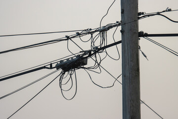 A mess of power, telecom, and cable television wires on a utility pole