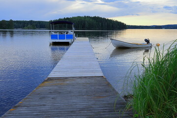 Bridge, water and boat. Landscape photo. Usken lake, Nora, Bergslagen, Sweden.