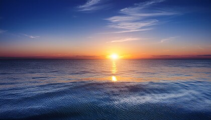 sun setting over calm waters at dusk