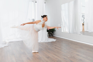Senior ballerina performing graceful dance routine in studio