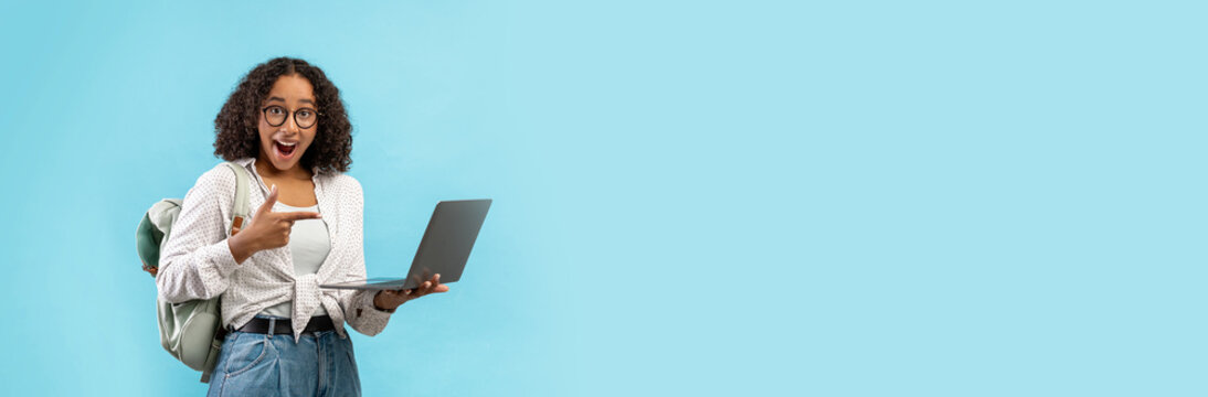 A joyful student shows enthusiasm while studying on her laptop, seated against a vibrant painted background that adds a cheerful atmosphere to her learning environment. - Powered by Adobe