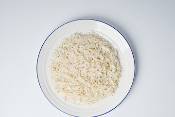 Cooked white rice in a plate, plan white rice in a white plate isolated on the white background shot in a soft studio lights