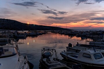 In the harbor or marina in the evening at sunset.