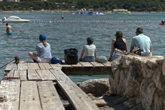 Family waiting on the boat dock for pickup.