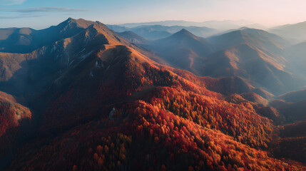 Aerial view of a mountain range covered in autumn foliage