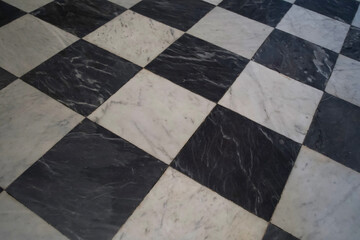 Black and white marble checkerboard floor pattern with polished surface and elegant design for...