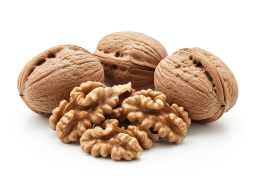 Close up of whole and shelled walnuts on a white food