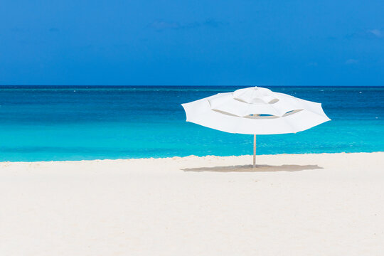 A lone beach umbrella on Eagle Beach on the island of Aruba. 