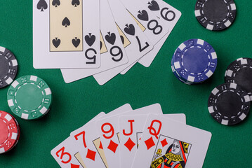 Playing card game poker in casino with chips, bets and risk. Cards and chips on elt