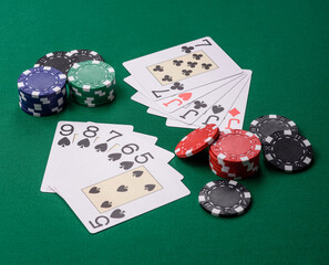 Playing card game poker in casino with chips, bets and risk. Cards and chips on elt