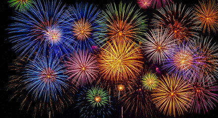 Fototapeta premium Vibrant explosion of colorful fireworks illuminating the night sky