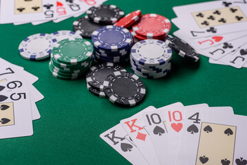 Playing card game poker in casino with chips, bets and risk. Cards and chips on elt
