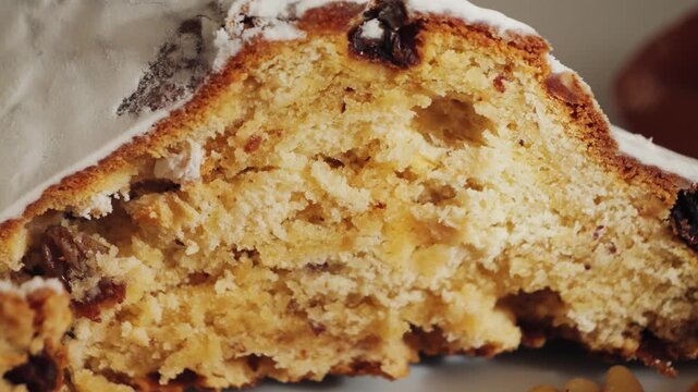 Close-up of a dessert Stollen. Bread with raisins, nuts, and candied fruit, with powdered sugar on top. Christmas desserts. High quality 4k footage
