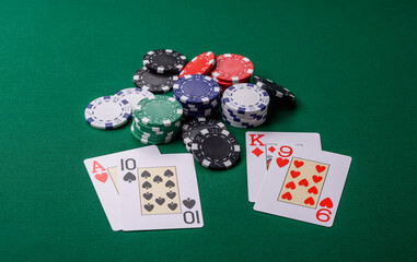 Playing blackjack or baccarat card game in casino with chips, bets and risk. Cards and chips on felt