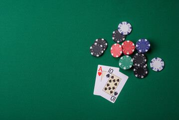 Playing blackjack or baccarat card game in casino with chips, bets and risk. Cards and chips on felt