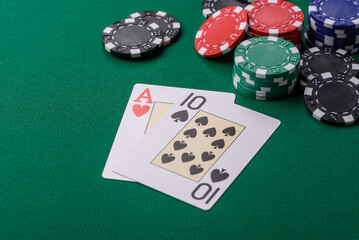 Playing blackjack or baccarat card game in casino with chips, bets and risk. Cards and chips on felt