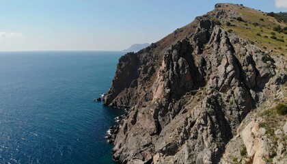 Majestic mountain range illuminated by golden sunlight, framed by a dense forest.