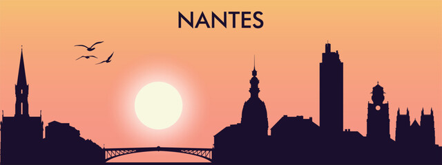 Obraz premium the silhouette of the city of Nantes against the sunset.