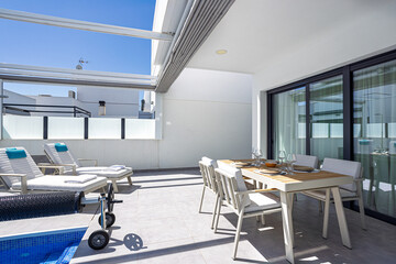 Terrace with outdoor dining and pool view