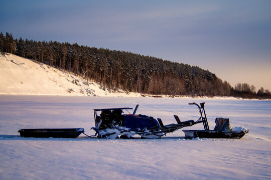 Winter fishing. Ice fishing. Fisherman, fishing on the ice. Electric snowmobile for fishing. Russia.
