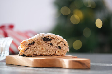 A delicious looking baked treat presented on a wooden board, showcasing various nuts and dried...