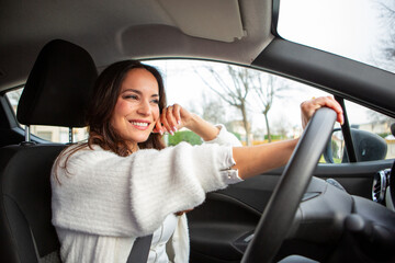 Fototapeta premium Smiling woman relaxing inside parked car